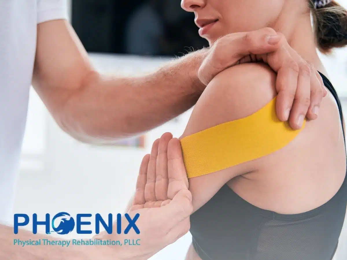 A physical therapist placing kinesio tape on a woman's arm in NY