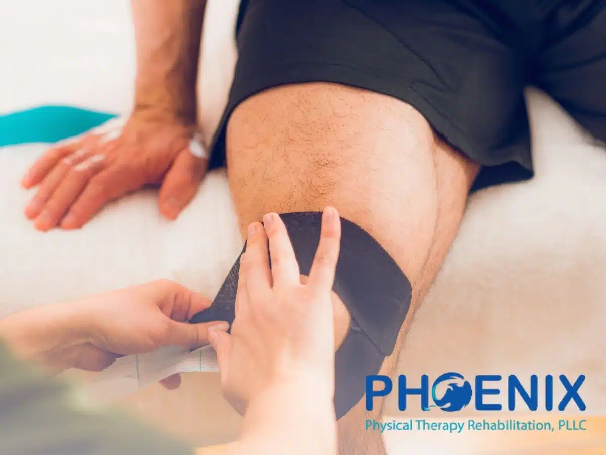 A physical therapist placing kinesio tape on a man's knee in NY