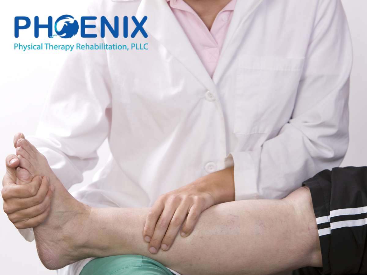 Physical therapist treating a patient's ankle at Phoenix Physical Therapy