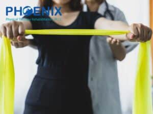 Physical therapist assisting a patient with resistance band exercises to improve Balance Disorders at Phoenix Physical Therapy Rehabilitation