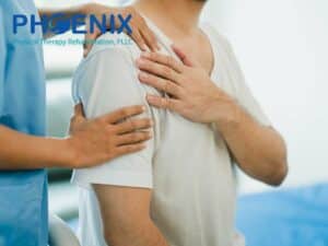 Therapist assisting patient with shoulder pain from sleeping at Phoenix Physical Therapy