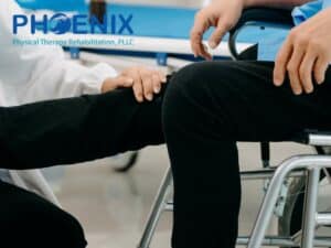 Physical therapy treatment for Multiple Sclerosis, with a therapist assisting a patient in a wheelchair during rehabilitation at Phoenix Physical Therapy.